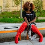 Katarra Parson sitting on curb outside in Grand Center